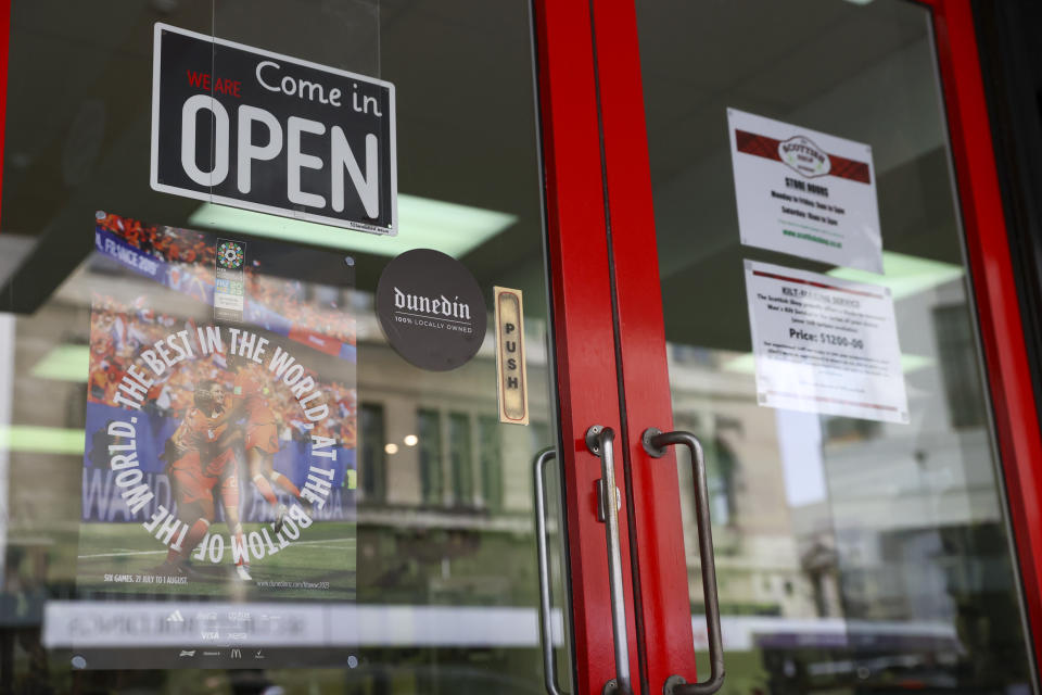 A flyer displayed in a window of a Dunedin business declares "The Best in the World At the Bottom of The World" poster in Dunedin, New Zealand, Wednesday, July 29, 2023.Women's World Cup host city Dunedin, at latitude of 45.88 degrees South is the southernmost city to ever host a World Cup tournament, men's or women's. (AP Photo/Matthew Gelhard)