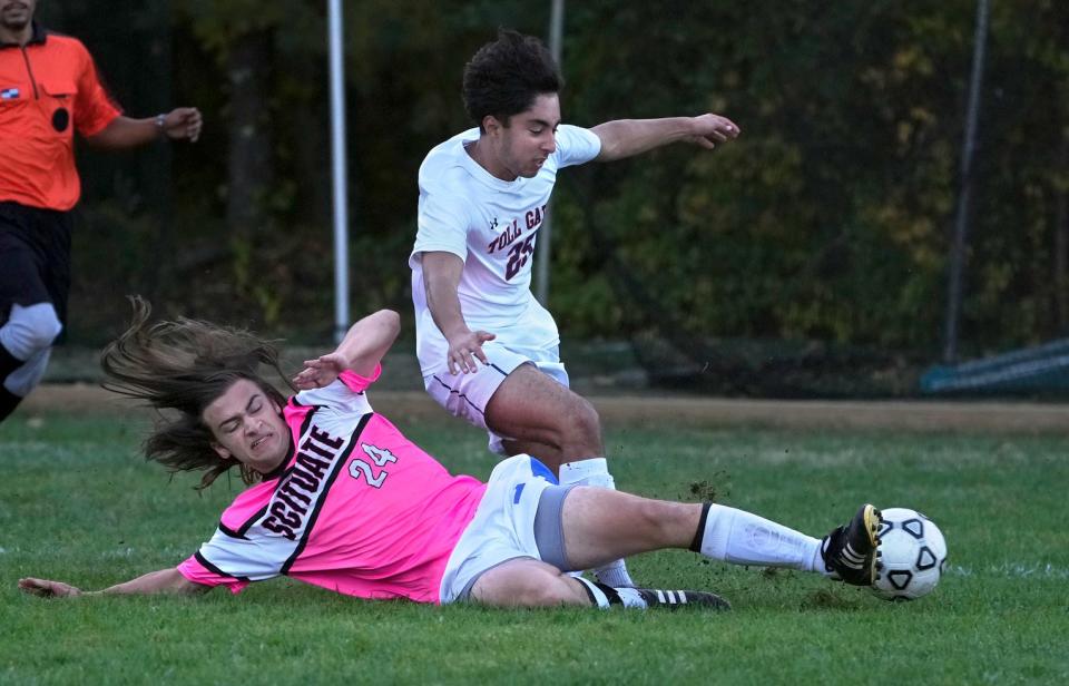 The Spartans' Jake Gurjian slides in an attempt to knock the ball away from the Titans' Edrees Heidari, who had two goals in the game on Tuesday.