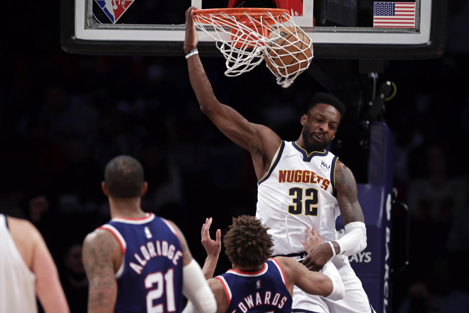 Denver Nuggets forward Jeff Green (32) dunks over Brooklyn Nets forward Kessler Edwards during the second half of an NBA basketball game Wednesday, Jan. 26, 2022, in New York. The Nuggets won 124-118. (AP Photo/Adam Hunger)