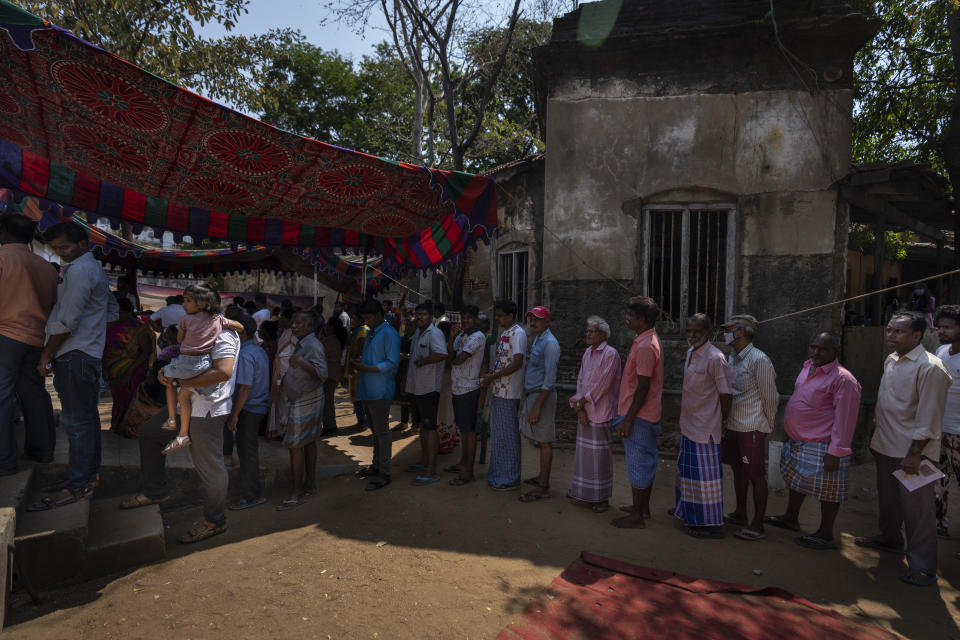 People wait to cast their votes during the first round of polling of India's national election in Chennai, southern Tamil Nadu state, Friday, April 19, 2024. Nearly 970 million voters will elect 543 members for the lower house of Parliament for five years, during staggered elections that will run until June 1. (AP Photo/Altaf Qadri)