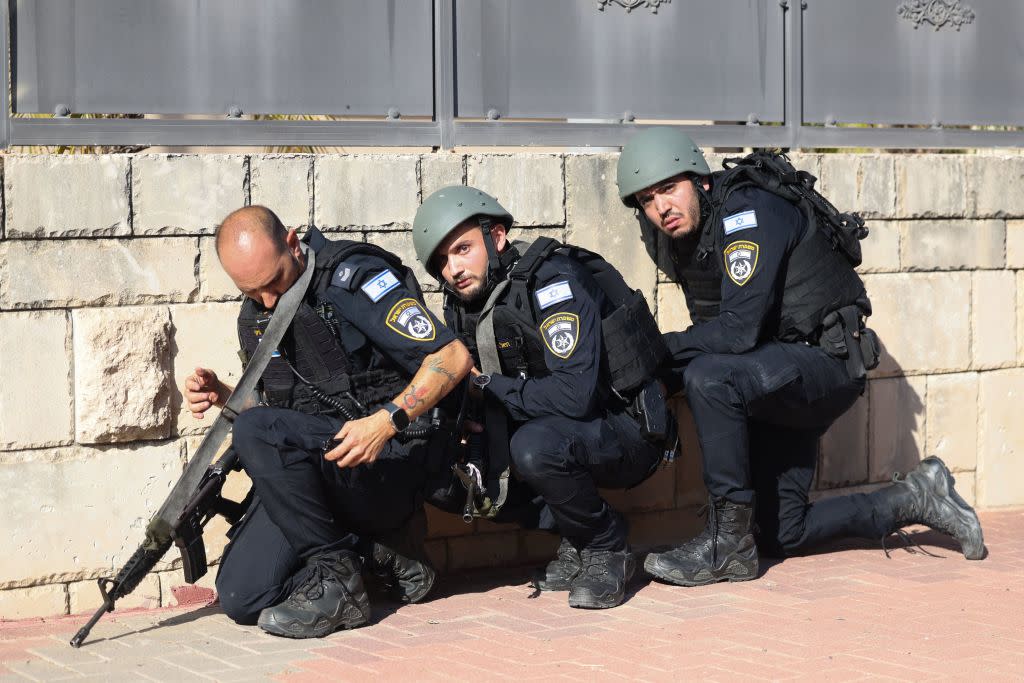  Members of the IDF take cover during a rocket attack. 