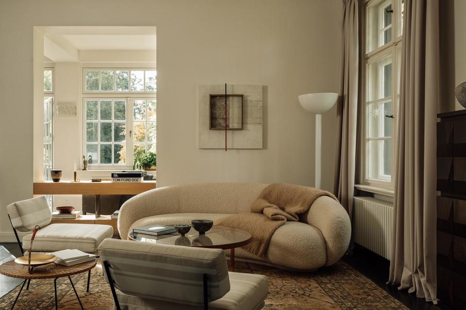 A living room with large croissant-shaped sofa