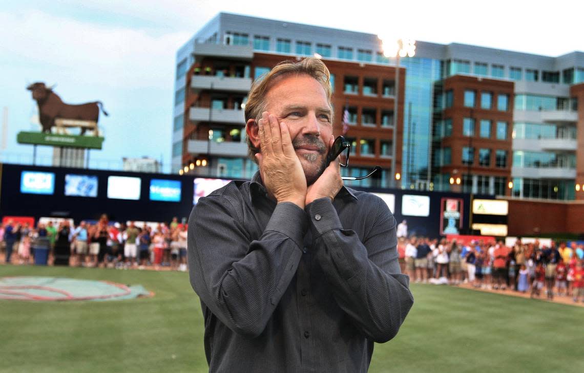 Actor Kevin Costner reacts as he enters the field for his Independence Day concert at the Durham Bull Athletic Park in 2008. Costner and his band were celebrating the 20th anniversary of the movie Bull Durham.