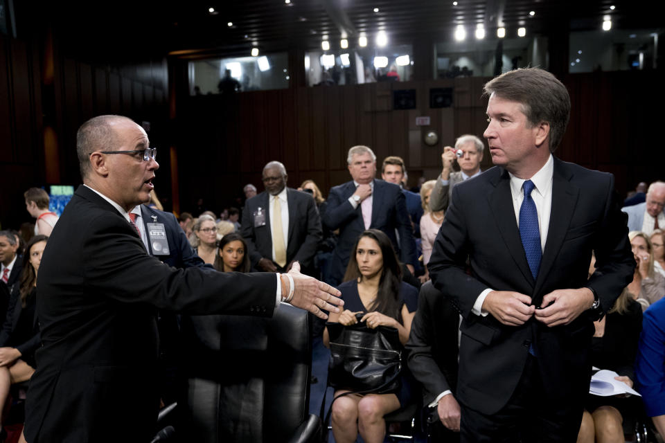 FILE - In this Tuesday, Sept. 4, 2018 file photo, Fred Guttenberg, the father of Jamie Guttenberg who was killed in the Stoneman Douglas High School shooting in Parkland, Fla., left, attempts to shake hands with President Donald Trump's Supreme Court nominee, Brett Kavanaugh, right, as he leaves for a lunch break while appearing before the Senate Judiciary Committee on Capitol Hill in Washington to begin his confirmation hearing. Kavanaugh did not shake his hand. Kavanaugh wrote in a response to questions from senators late Wednesday, Sept. 12, 2018, that he assumed the man had been a protester. (AP Photo/Andrew Harnik, File)