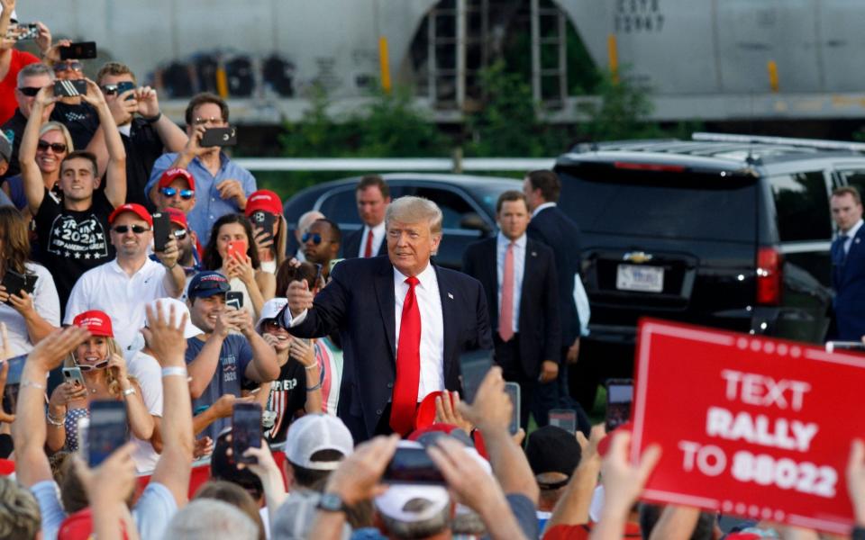 Supporters cheer as former US president Donald Trump arrives for his campaign-style rally - AFP