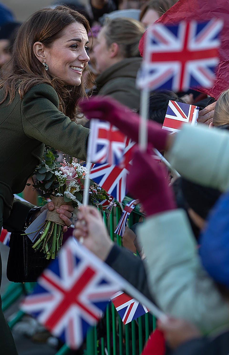 Britain's Catherine, Duchess of Cambridge greets to wellwishers waving Union flags after visiting City Hall in Centenary Square, Bradford on January 15, 2020. (Photo by Charlotte Graham / POOL / AFP) (Photo by CHARLOTTE GRAHAM/POOL/AFP via Getty Images)