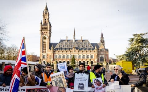 Protesters demonstrate in support of the Rohingya outside the Hague's Peace Palace - Credit: AFP