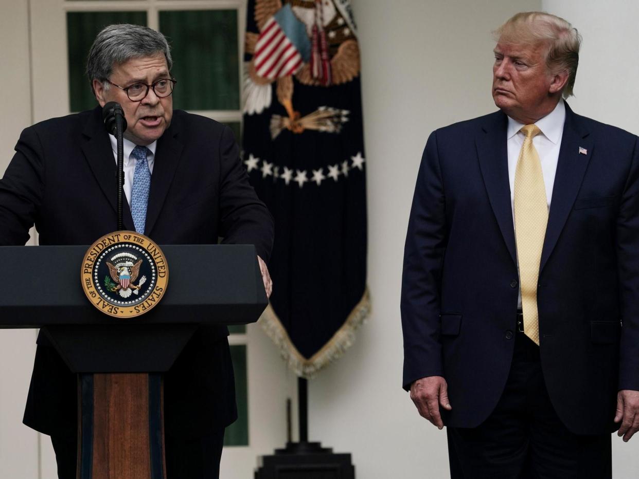 Attorney General William Barr speaks as Donald Trump looks on: Getty Images