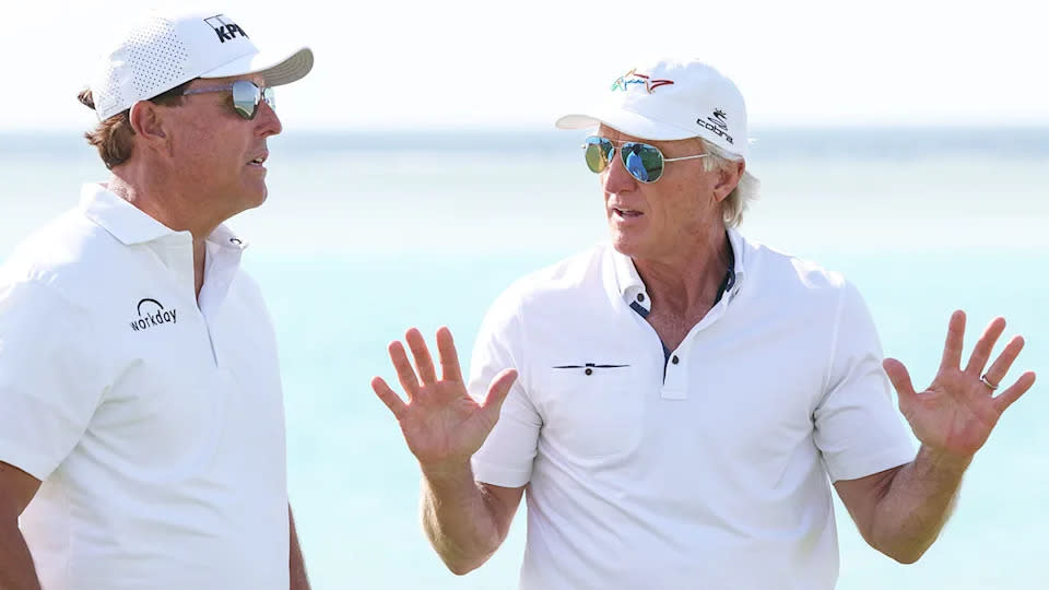 From left to right, Phil Mickelson chatting with Aussie golf legend Greg Norman.