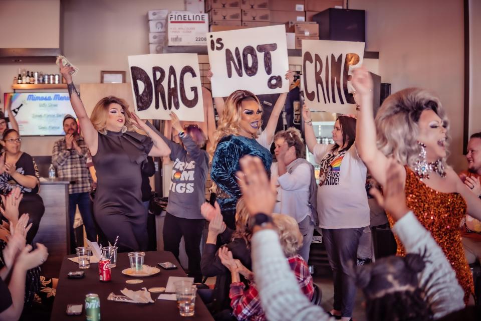 Signs read "drag is not a crime" at a March 19 Carolina Drag Brunch event at Gaston Brewing Taproom, 421 Chicago Drive.