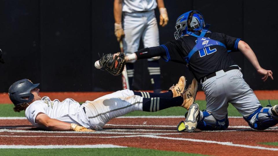 Middleton’s Elijah Wilson slides safely into home in the bottom of the seventh inning to force extra innings Thursday.