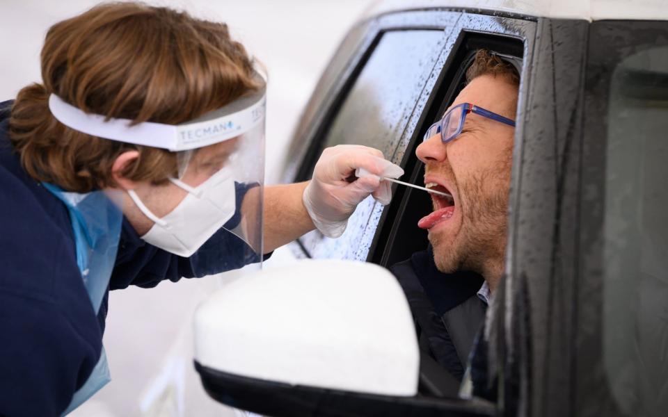 Nick Markham, the founder of ExpressTest, reacts as he takes a PCR swab test at Gatwick Airport - Leon Neal/Getty Images Europe