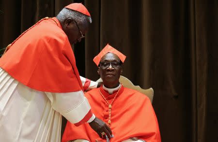 Newly elevated Cardinal Jean Zerbo (R) sits before meeting friends and relatives after taking part in the Consistory at the Vatican, June 28, 2017. REUTERS/Alessandro Bianchi