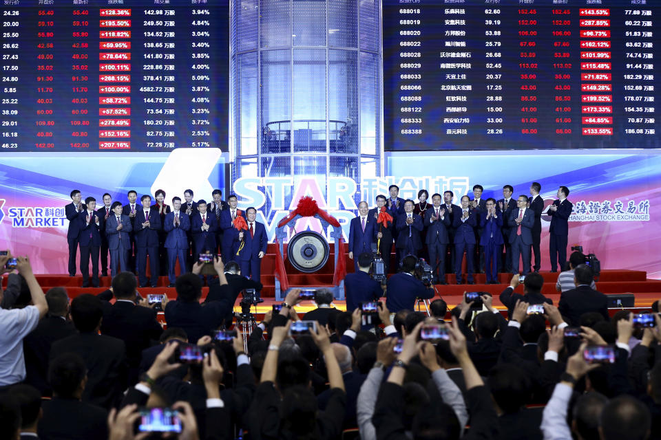 Li Qiang, center left, Shanghai's Party chief, and Yi Huiman, center right, chairman at China Securities Regulatory Commission, and the heads of 25 companies celebrate the launch of the SSE STAR Market in the hall of Shanghai Securities Exchange in Shanghai, China on July 22, 2019. | Chinatopix/AP