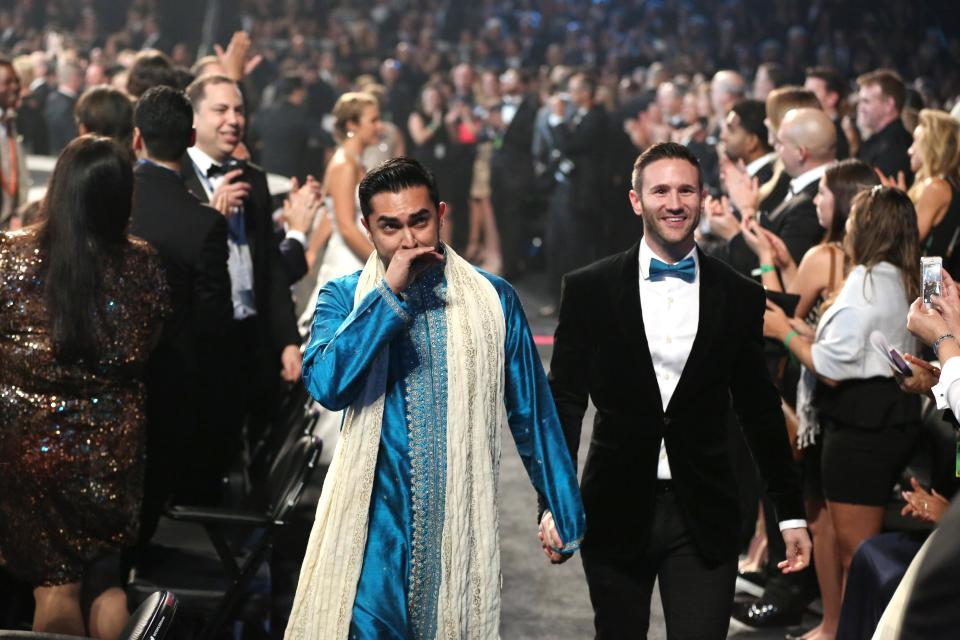 ADDITIONAL WEDDING DETAILS INCLUDED - Audience members participate in a same sex wedding during a performance of "Same Love" by Macklemore and Ryan Lewis at the 56th annual Grammy Awards at Staples Center on Sunday, Jan. 26, 2014, in Los Angeles. With Queen Latifah presiding from the stage and the music playing, 33 straight and gay couples lined the aisle dressed in wedding finery. Under Latifah's command, they exchanged rings near the end of Sunday night's show televised on CBS. (Photo by Matt Sayles/Invision/AP)