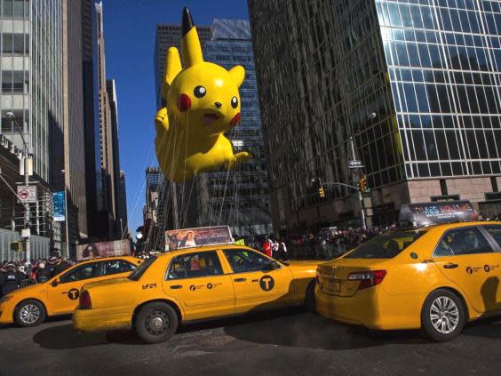 A Pikachu balloon floats down 6th Avenue during the Macy’s Thanksgiving Day Parade in New York (Reuters)