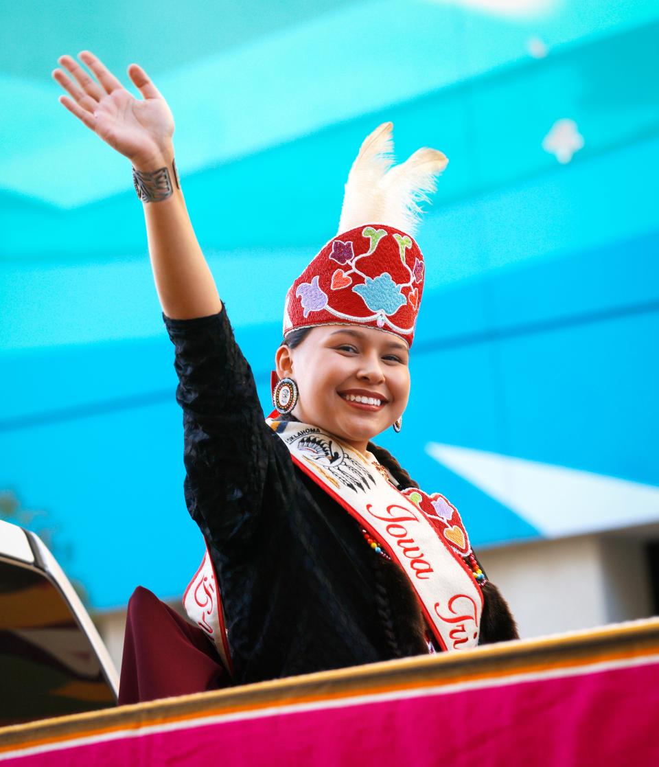 Madison Switch-Fixico, 2022-23 Iowa Tribal Princess, waves during the 2022 Red Earth Parade, part of the Red Earth FallFest, in downtown Oklahoma City.