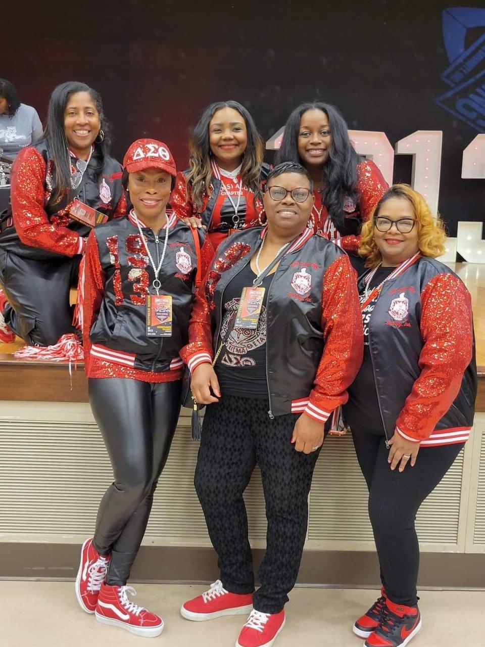 A group of Deltas poses for a photo in the sorority’s signature red colors.