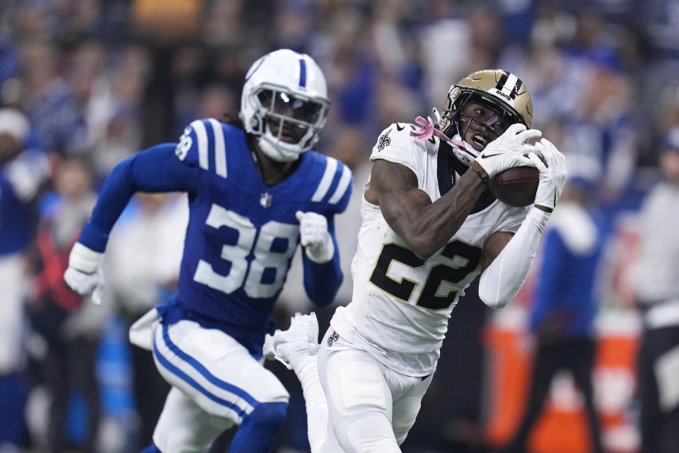 New Orleans Saints wide receiver Rashid Shaheed (22) catches a 58-yard touchdown reception as Indianapolis Colts cornerback Tony Brown (38) defends during the first half of an NFL football game Sunday, Oct. 29, 2023 in Indianapolis. (AP Photo/Michael Conroy)