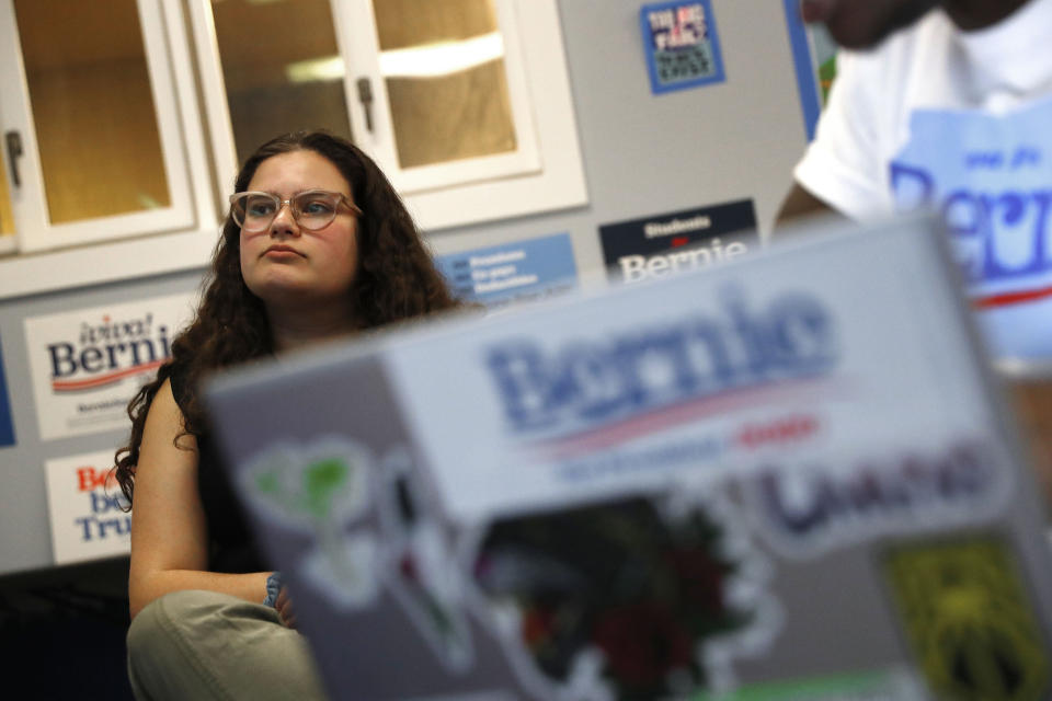 In this March 3, 2020, photo, Jaclyn Schess, a supporter of Democratic presidential candidate Sen. Bernie Sanders, I-Vt., watches returns during a Super Tuesday watch party in Ann Arbor, Mich. (AP Photo/Paul Sancya)
