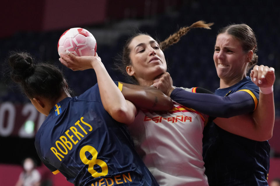 <p>Spain's Lara Gonzalez Ortega, center, challenges for the ball with Sweden's Jamina Roberts, left, and Carin Stromber during the women's Preliminary Round Group B handball match between Spain and Sweden at the 2020 Summer Olympics, Sunday, July 25, 2021, in Tokyo, Japan. (AP Photo/Pavel Golovkin)</p> 