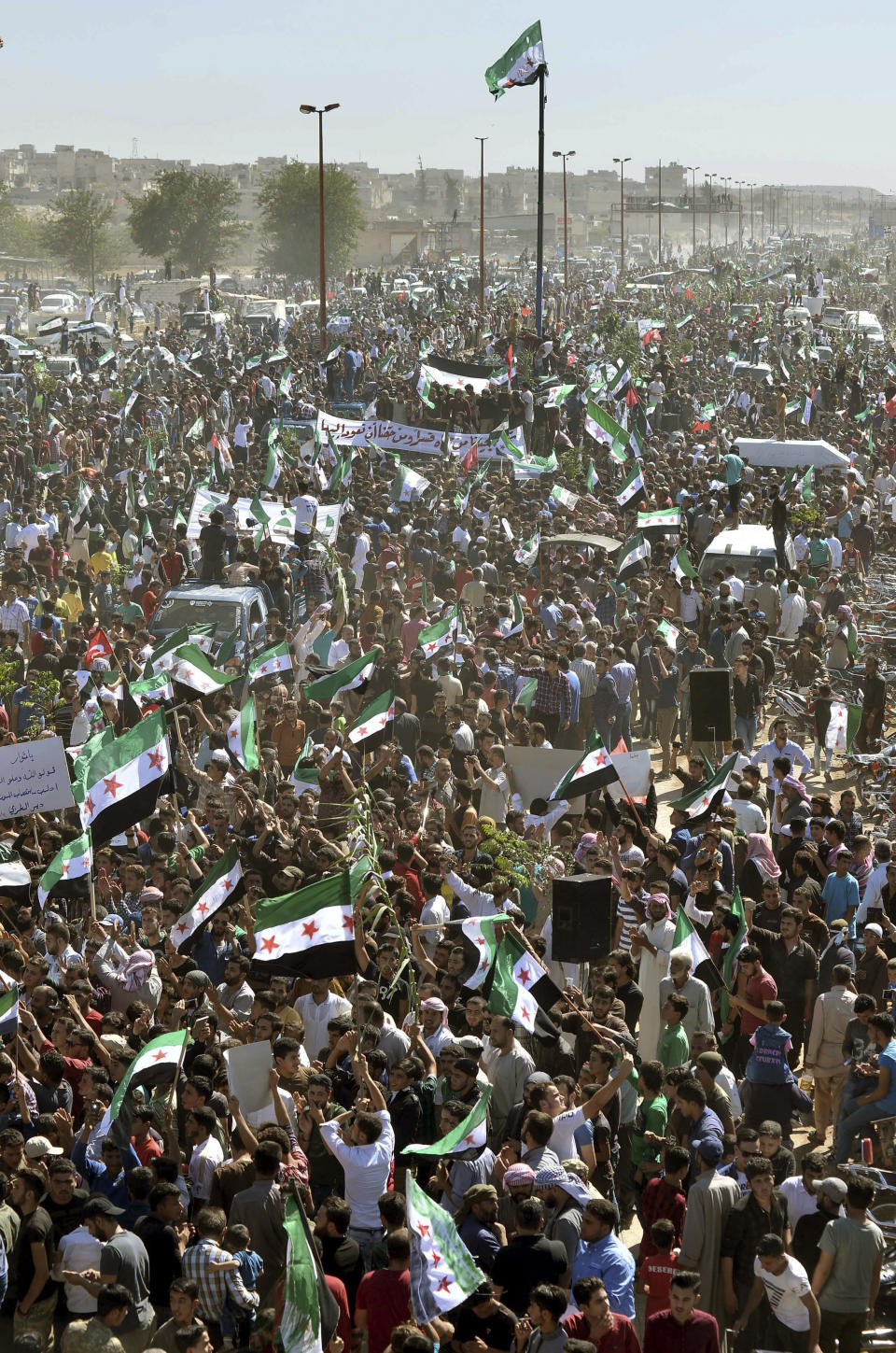 Potesters attend a demonstration against the Syrian government's expected offensive to Idlib, in the northwestern town of Maarat al-Numan, also known as al-Maʿarra, south of Idlib, Syria, Friday, Sept 14, 2018. (Ugur Can/DHA via AP)