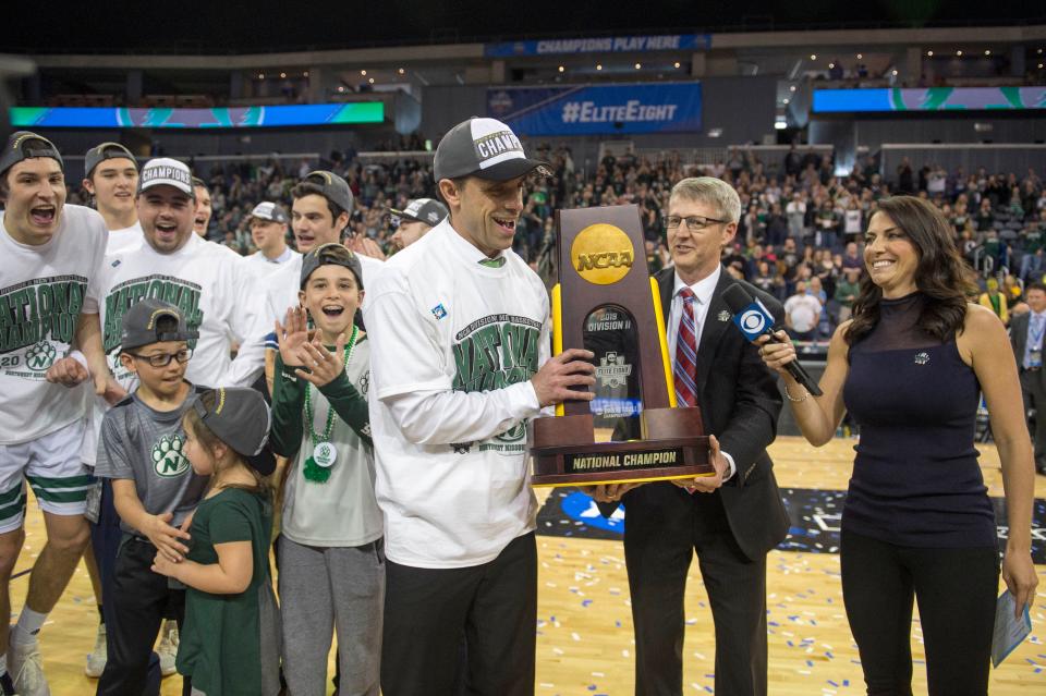 Northwest Missouri State coach Ben McCollum holds the NCAA Division II championship trophy at Ford Center in Evansville, Ind., on March 30, 2019. McCollum has been hired as Drake's new men's basketball coach.