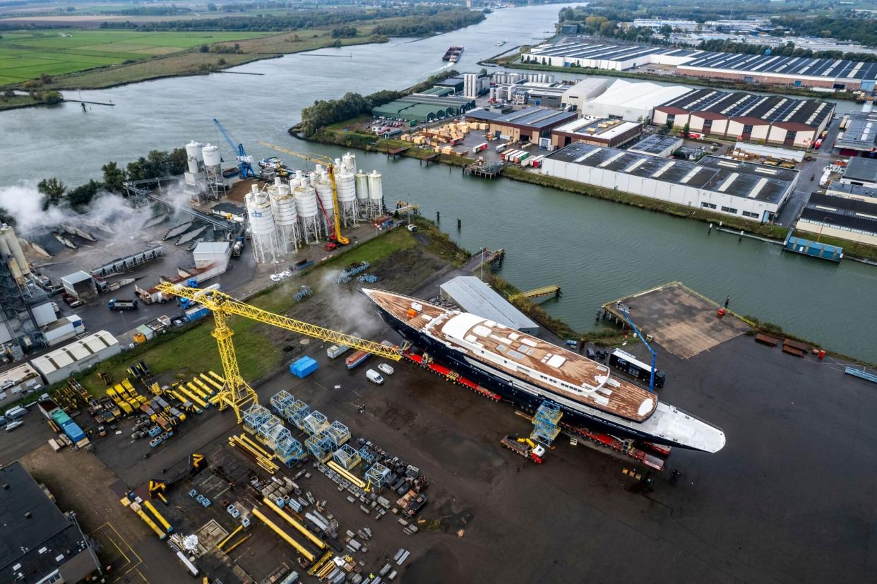 Mandatory Credit: Photo by Guy Fleury/AP/Shutterstock (12789193a) View of a yacht, reportedly being built for Amazon founder Jeff Bezos, on the wharf in Zwijndrecht, near Rotterdam, Netherlands, . A plan to dismantle a historic bridge in the heart of Dutch port city Rotterdam so that the huge yacht can get to the North Sea is unlikely to be plain sailing. Reports this week that the city had already agreed to take apart the recently restored Koningshaven Bridge, known locally as De Hef sparked anger in the city, with one Facebook group set up calling for people to pelt the multimillion dollar yacht with rotten eggs Bridge Spat, Zwijndrecht, Netherlands - 20 Oct 2021