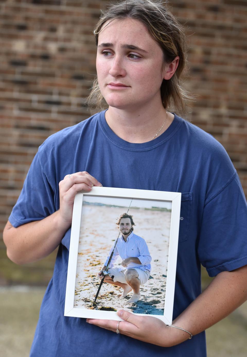 Emma Needham listens to her mother speak about her brother Sam Needham as the family gathered Wednesday morning outside Barnstable District Court. Sam Needham was killed on Tuesday while riding his motorcycle along Route 28 in Marstons Mills. Richard Collins, 71, of Ispwish was arraigned on charges in connection with the crash.