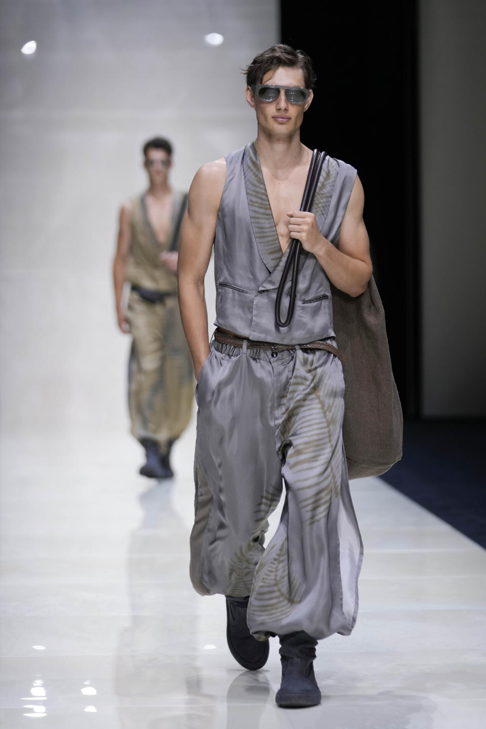 A model wears a creation as part of the Giorgio Armani Men's Spring Summer 2025 collection, that was presented in Milan, Italy, Monday, June 17, 2024. (AP Photo/Luca Bruno).