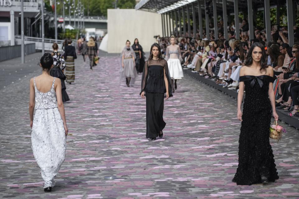 Models wear creations for the Chanel Haute Couture Fall/Winter 2023-2024 fashion collection presented in Paris, Tuesday, July 4, 2023. (AP Photo/Christophe Ena)