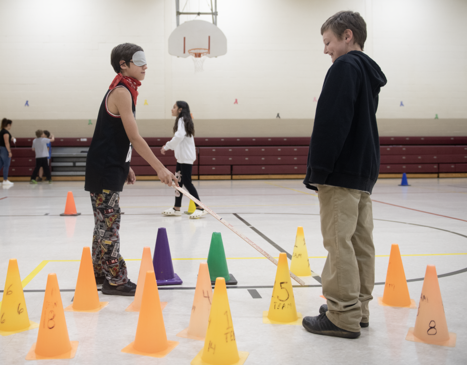 Gabriel Kinzer, 9, instructs Hextor Shoemaker, 10, during the Blindfolded Buddy Walk, at the vision impairment activity during Southeast intermediate and primary schools' Abilities Week.