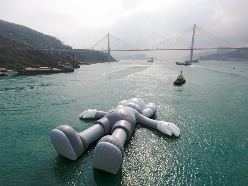 A 100-plus-foot-long inflatable KAWS sculpture in Hong Kong's Victoria Harbour in March.