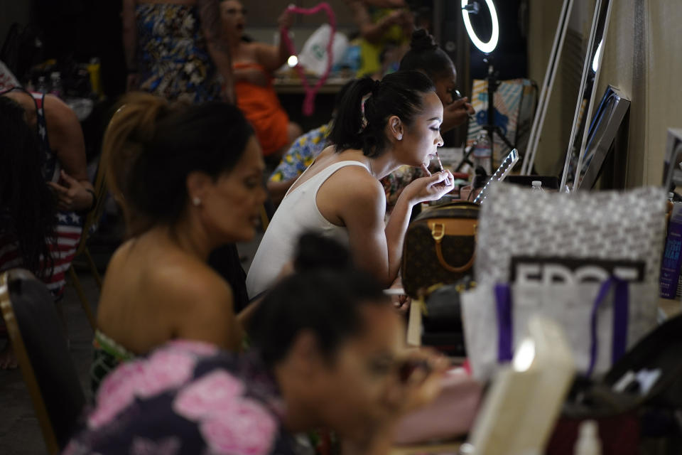Kiana Jacobs applies makeup before performing in the Mahu Magic drag show at the Western Regional Native Hawaiian Convention, Tuesday, June 20, 2023, in Las Vegas. (AP Photo/John Locher)
