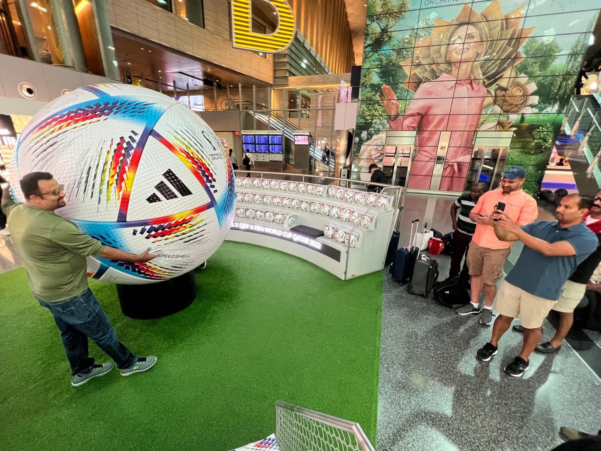 Global gathering: Fans with a giant football at Hamad International Airport in Doha (Simon Calder)