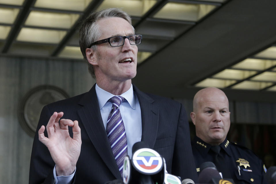 FBI Special Agent in Charge David Johnson, left, speaks next to San Francisco Police Chief Greg Suhr at a news conference in San Francisco, Monday, Jan. 6, 2014. The FBI says a Chinese national has been arrested in the investigation of a fire set intentionally at the Chinese Consulate in San Francisco. Johnson said Monday that 39-year-old Yan Feng of Daly City was arrested Friday after he called police in the San Francisco suburb. (AP Photo/Jeff Chiu)