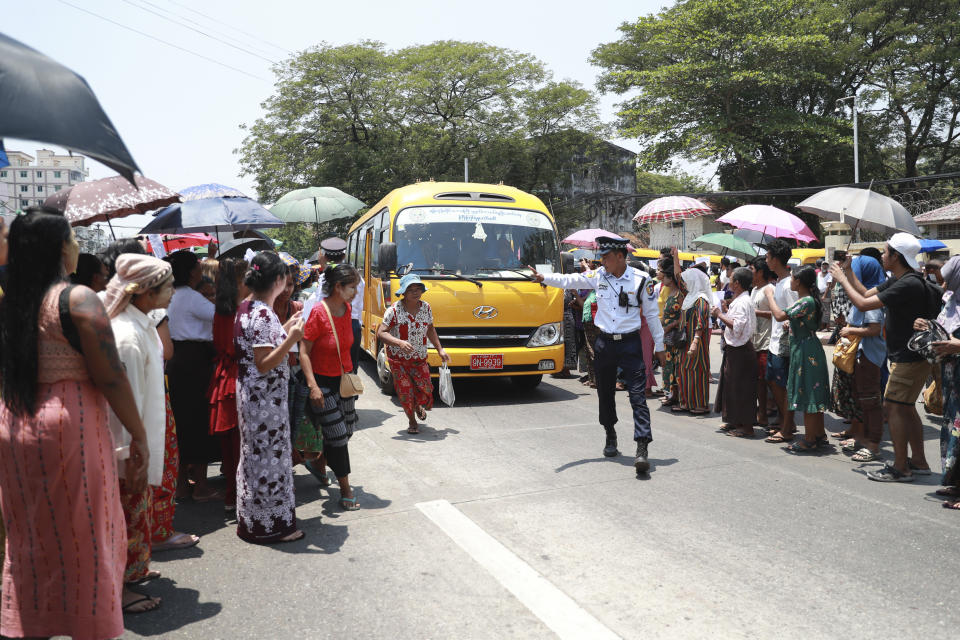 A bus carrying released prisoners is welcomed by family members and colleagues after leaving Insein Prison Wednesday, April 17, 2024, in Yangon, Myanmar. Myanmar’s jailed former leader Aung San Suu Kyi has been moved from prison to house arrest as a health measure due to a heat wave, the military government said. On Wednesday it also granted amnesty for over 3,000 prisoners to mark this week’s traditional New Year holiday. (AP Photo/Thein Zaw)