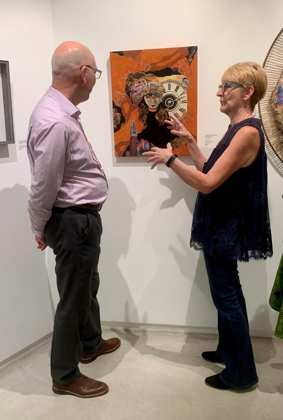 Ulrike and Merritt Price look at art at the Artists Council at The Galen.