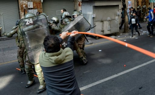 Pitched battles between police and protesters broke out during a rally to commemorate victims of the Pinochet years