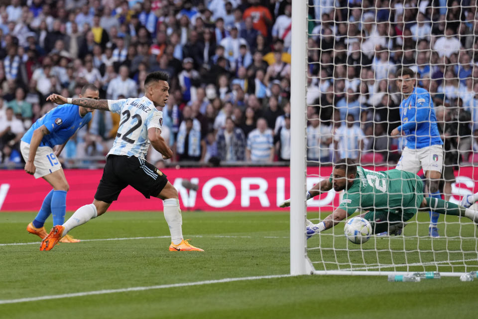 Argentina's Lautaro Martinez, second from left, scores his side's opening goal during the Finalissima soccer match between Italy and Argentina at Wembley Stadium in London , Wednesday, June 1, 2022. (AP Photo/Matt Dunham)