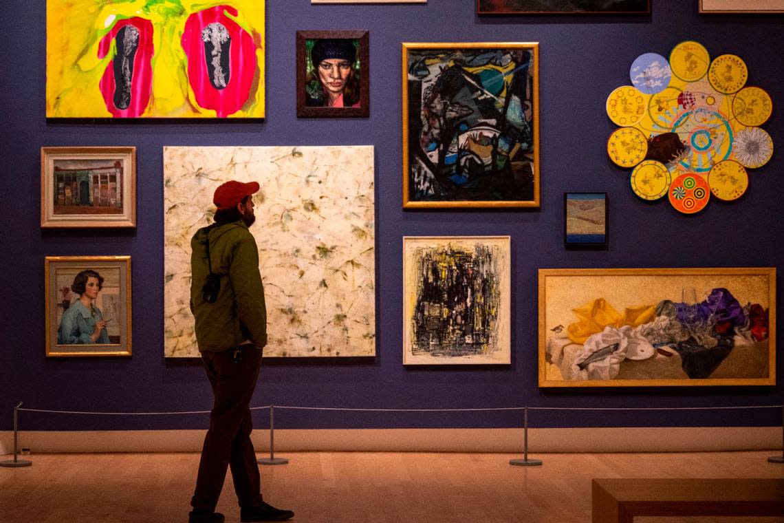 Nick Cuny, of Tacoma, looks at a wall of paintings at the Painting Deconstructed: Selections from the Northwest Collection in the Tacoma Art Museum on Dec. 16, 2022.