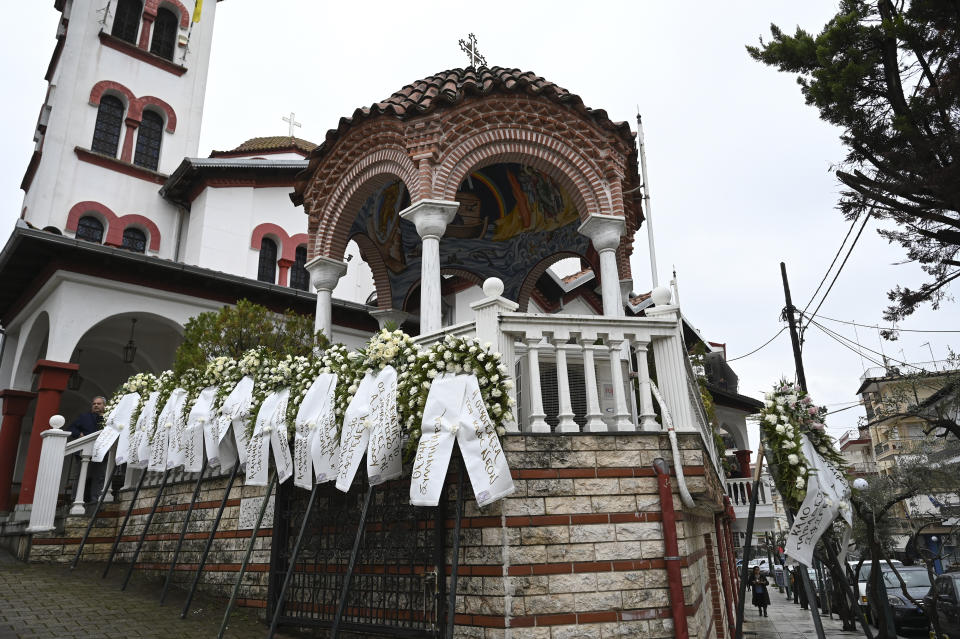 Wreaths are placed outside an Orthodox church during the funeral of 23-year old Ifigenia Mitska, at Giannitsa town, northern Greece, Saturday, March 4, 2023. Over 50 people — including several university students — died when a passenger train slammed into a freight carrier just before midnight Tuesday. The government has blamed human error and a railway official faces manslaughter charges. (AP Photo/Giannis Papanikos)
