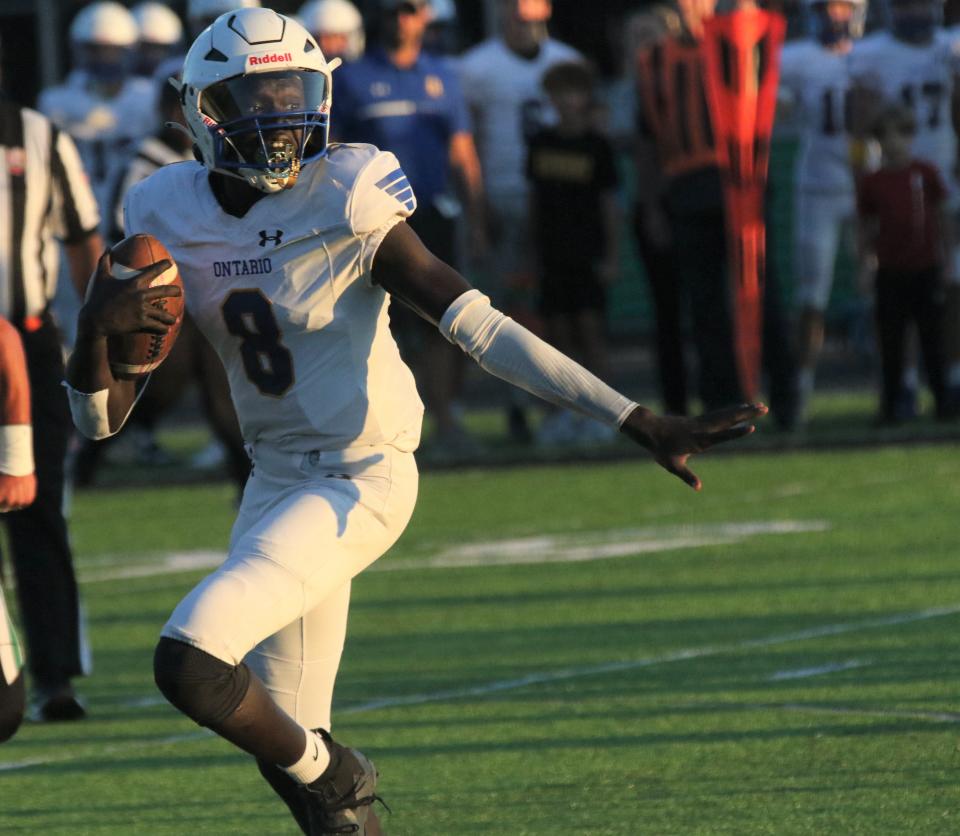 Ontario quarterback Bodpegn Miller guides his blockers during a long run that led to a 45-0 win over Clear Fork on Friday night.