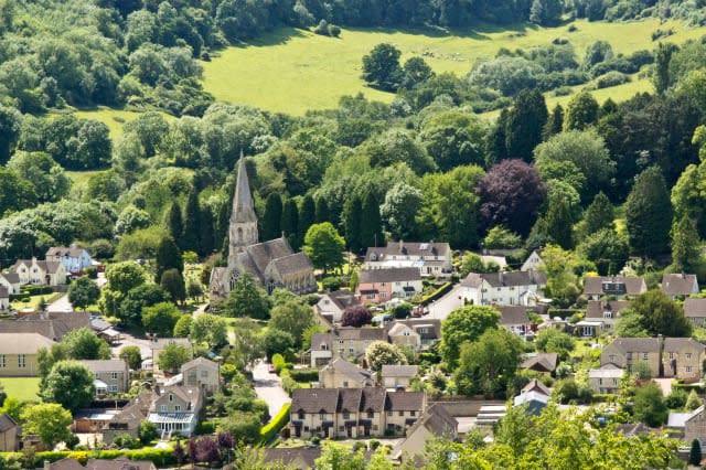 View looking down on Woodchester Church and village near Stroud, Gloucestershire, a pretty village in the Cotswolds