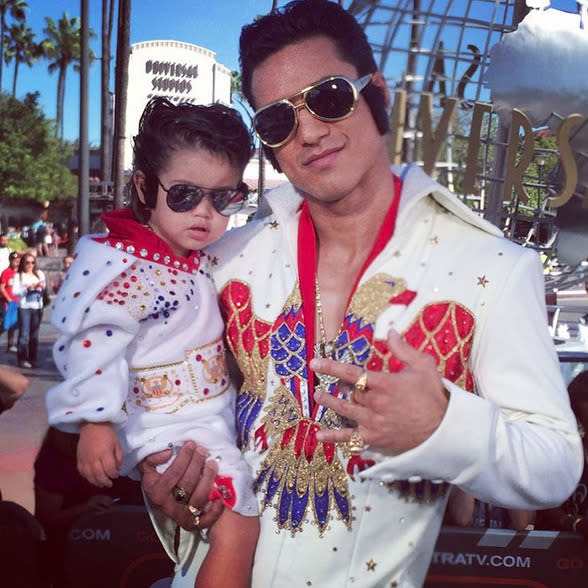 Mario Lopez chose a royally recognizable costume to wear while hosting 'Extra,’ as well as a similarly dressed (but much smaller) co-host in his 2-year-old son, Dominic. "Elvis & Mini-Elvis are hosting @ExtraTV today… #ThankyouThankYouVeryMuch #LopezBoys #Halloween,” he captioned it. (Instagram)