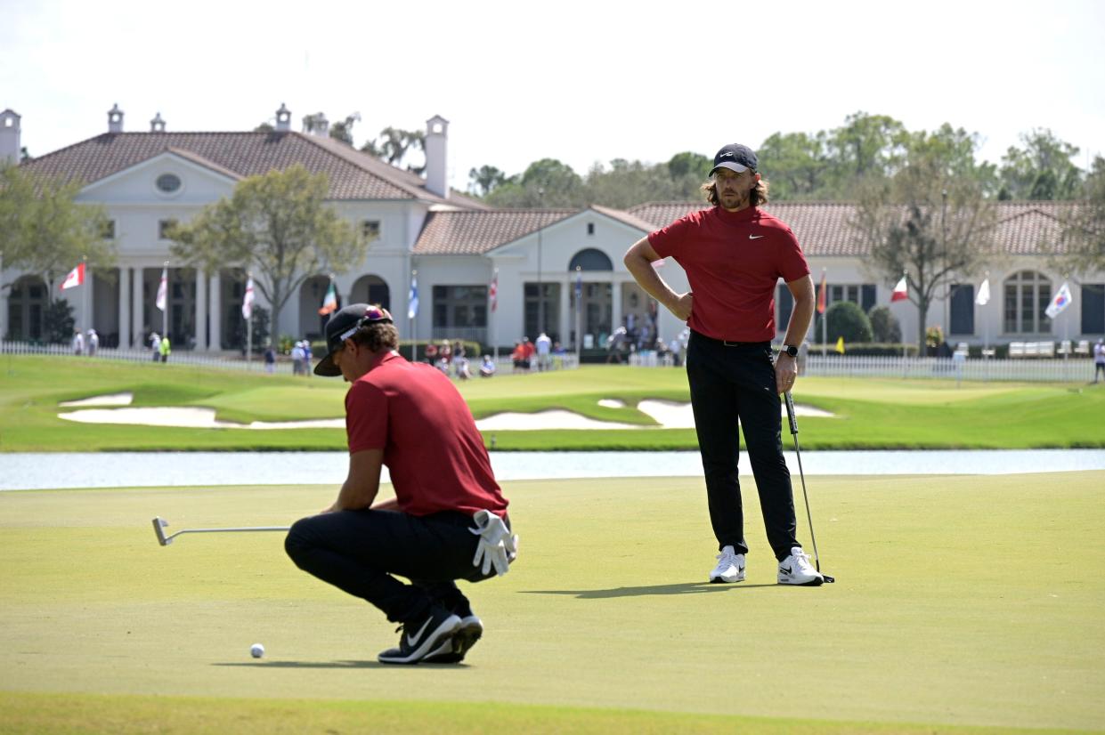 Cameron Champ (left) and Tommy Fleetwood were just two of the golfers sporting Tiger Woods' final-round colors on Sunday.