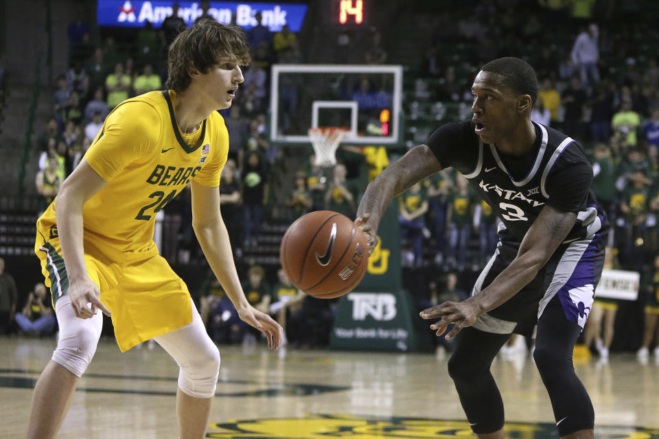 Kansas State guard DaJuan Gordon (3) passes the ball past Baylor guard Matthew Mayer (24) in the first half of an NCAA college basketball game, Tuesday, Feb. 25, 2020, in Waco, Texas. (AP Photo/ Jerry Larson)