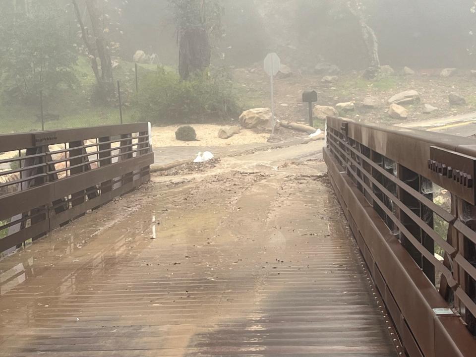 Floodwaters rush down a street in Montecito, California on Monday (via REUTERS)