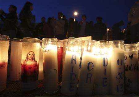 Fans gather near a makeshift shrine at an unofficial memorial event for "Fast and Furious" star Paul Walker in Santa Clarita, California December 8, 2013. REUTERS/Jonathan Alcorn