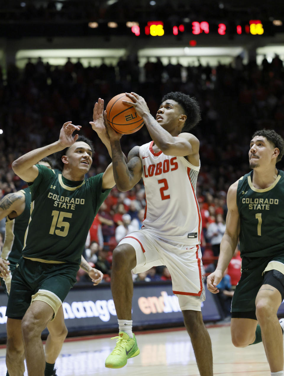 New Mexico guard Donovan Dent drives to the basket between Colorado State's Jalen Lake, left, and Joel Scott for the winning basket in the closing seconds of an NCAA college basketball game Wednesday, Feb. 21, 2024, in Albuquerque, N.M. (AP Photo/Eric Draper)